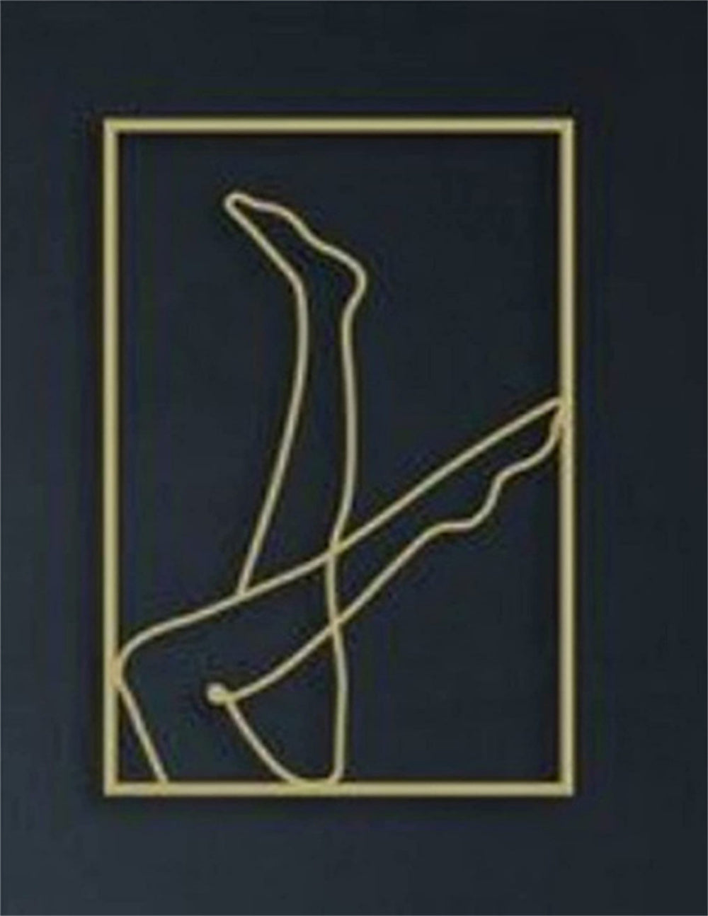 Gold feminine art wall decoration featuring two legs in the air 