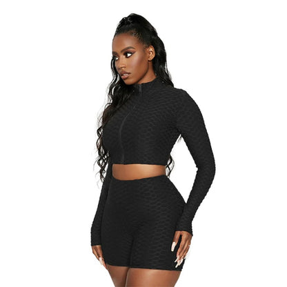 Black luxury activewear set with long sleeve crop top and matching shorts